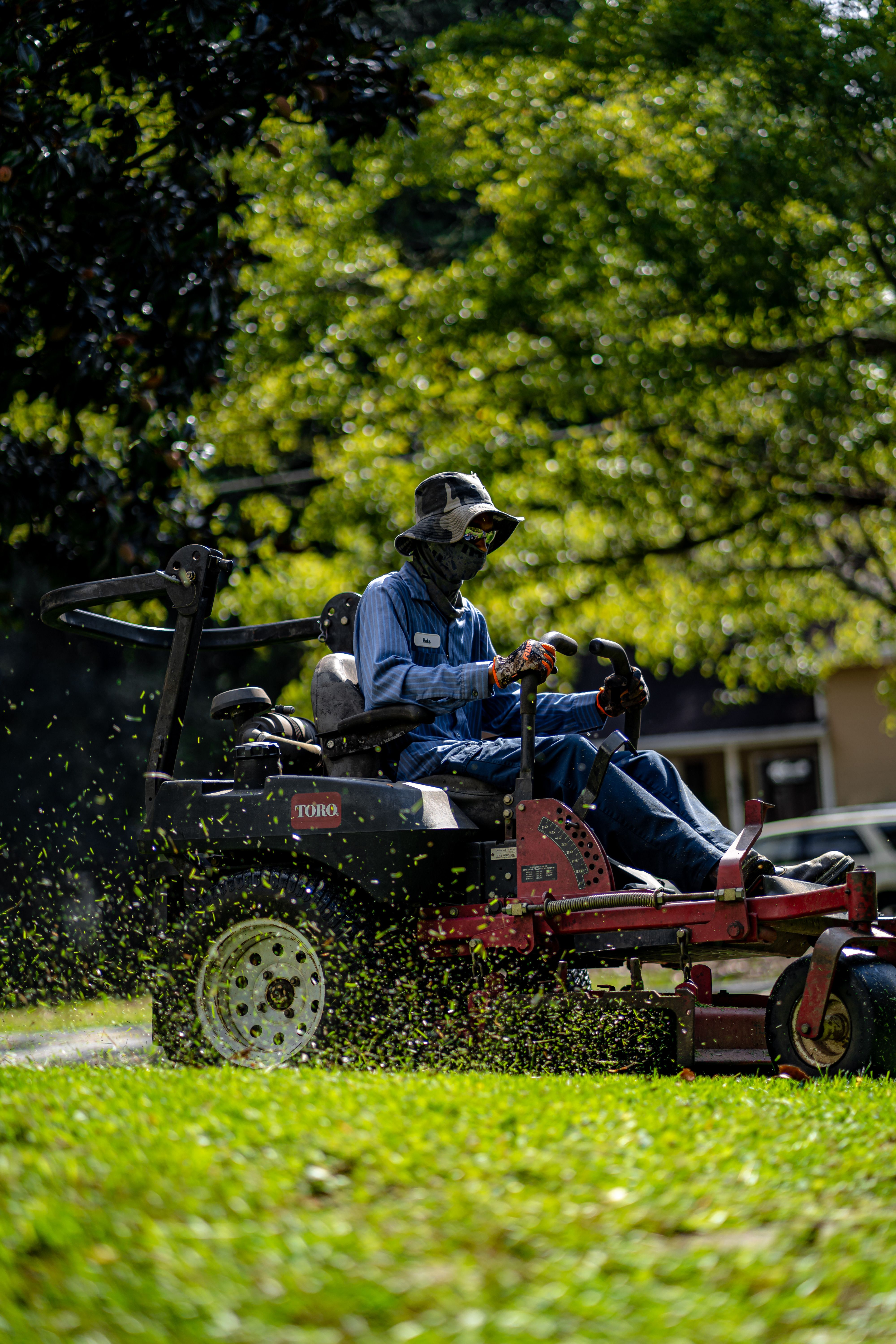 Commercial landscaping crew mowing and trimming grounds at an office building in Bucks County, PA